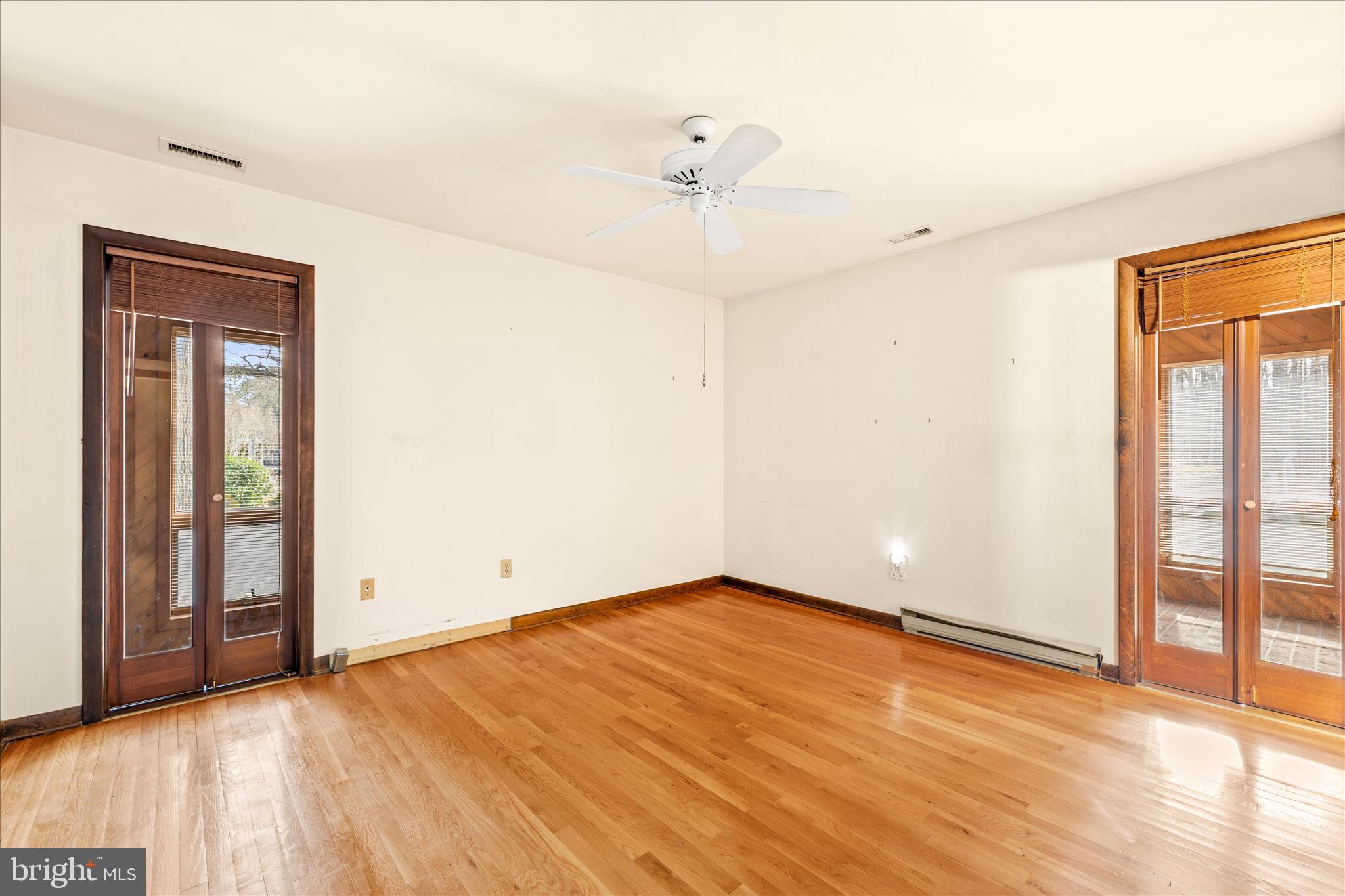 4170 Coulbourn Mill Road Salisbury, MD 21804 - Photo 25 of 47 wooden floor in an empty room with a window