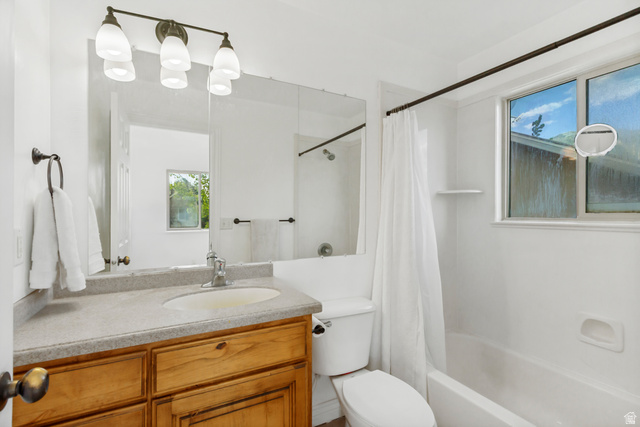 1585 South 910 West Payson, UT 84651 - Photo 16 of 32 Bathroom featuring a wood-finish vanity with an integrated sink, a large mirror, and a three-light fixture