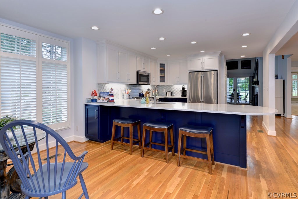 104 The Green Williamsburg, VA 23185 - Photo 11 of 50 a living room with stainless steel appliances kitchen island granite countertop furniture a kitchen island a sink and a wooden floor