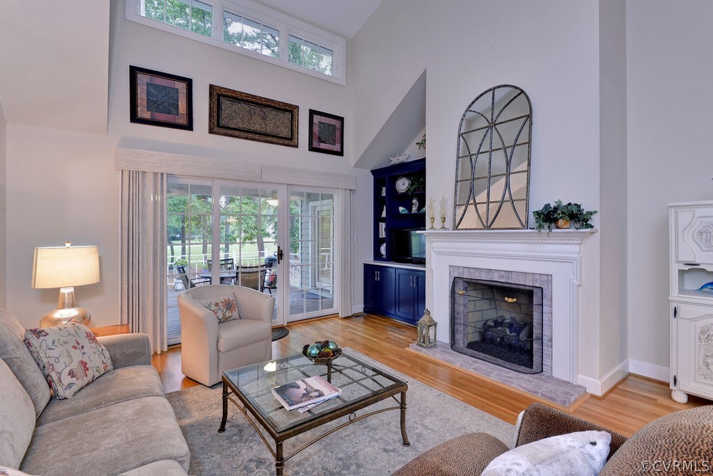 104 The Green Williamsburg, VA 23185 - Photo 15 of 50 a living room with furniture a fireplace and a floor to ceiling window