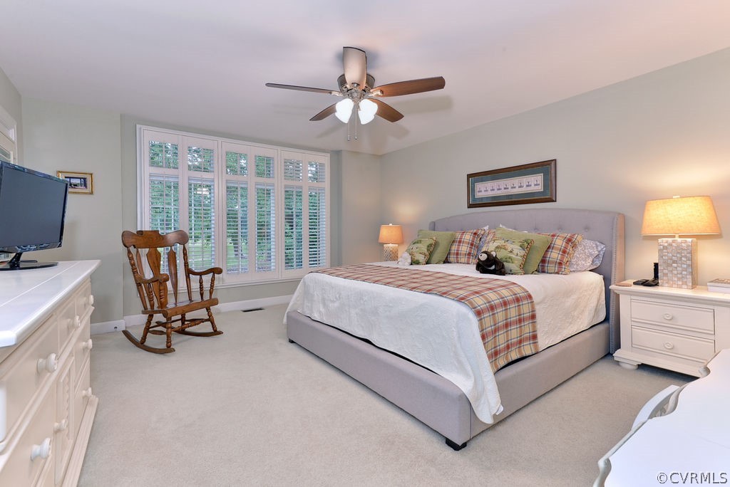 104 The Green Williamsburg, VA 23185 - Photo 18 of 50 a bedroom with a bed a chair and a chandelier