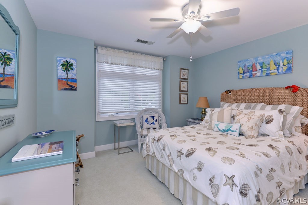 104 The Green Williamsburg, VA 23185 - Photo 25 of 50 a bedroom with a bed and a table in it