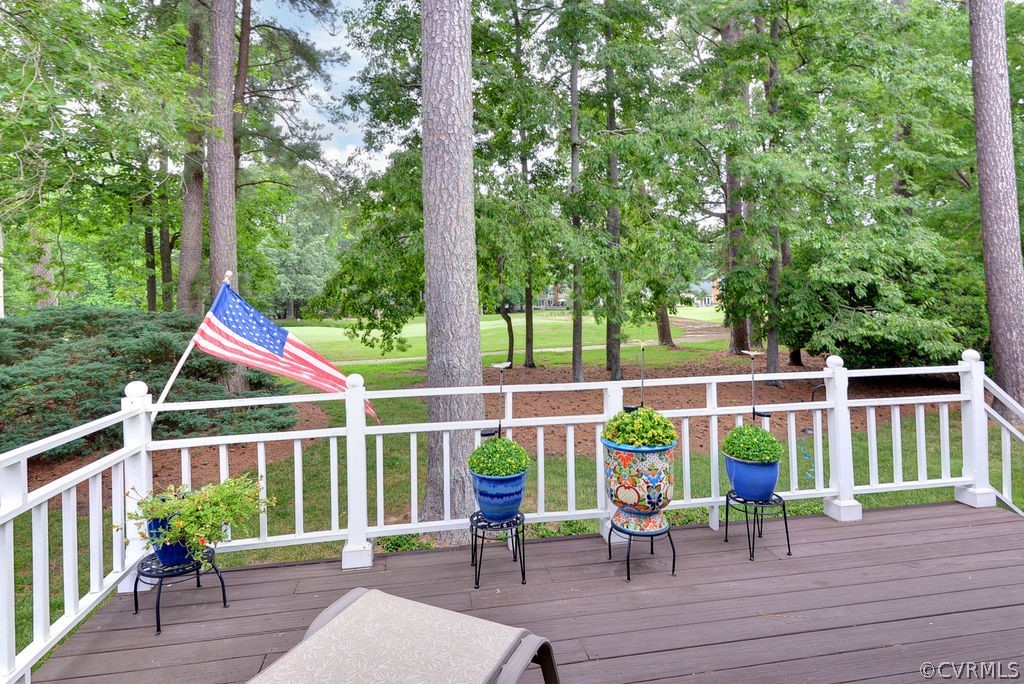 104 The Green Williamsburg, VA 23185 - Photo 31 of 50 a view of a deck with chairs and wooden floor next to a yard