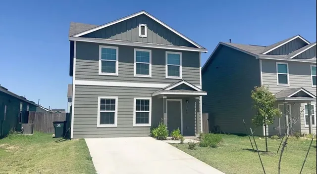 a front view of a house with a yard