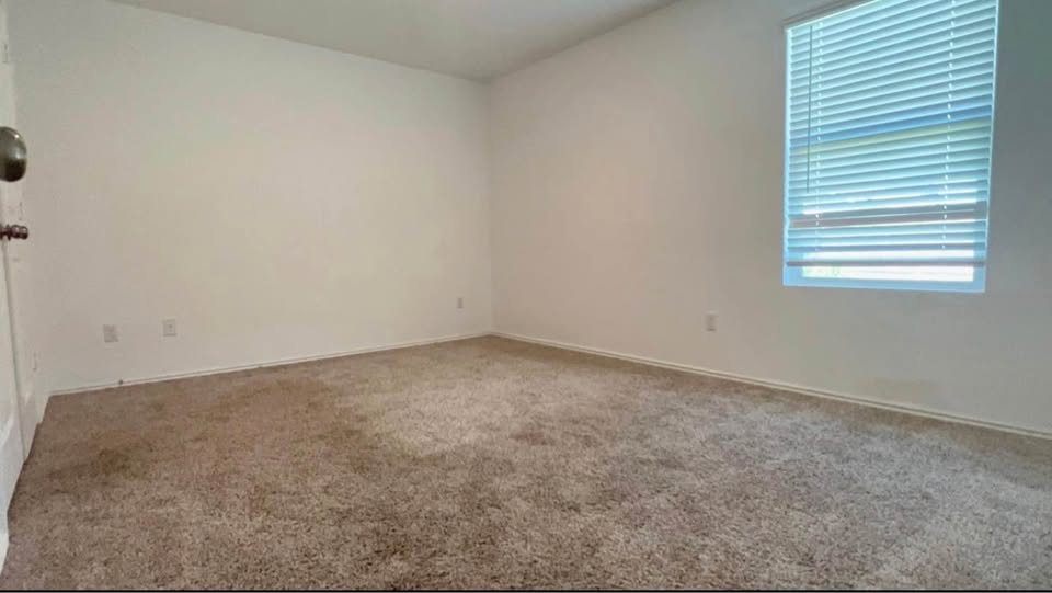 343 Mica Trail Maxwell, TX 78656 - Photo 5 of 9 Empty room featuring carpet floors and baseboards