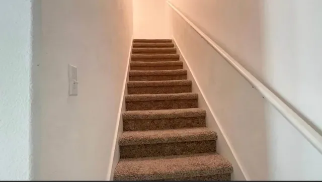 a view of hallway with a bathroom