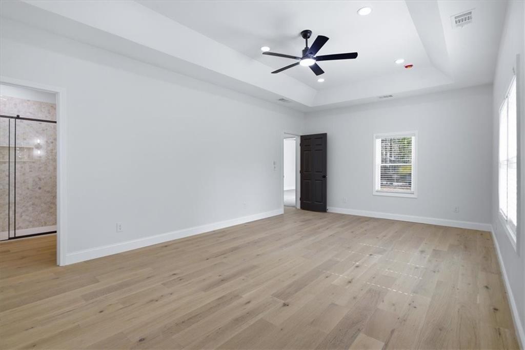 4911 Lower Jersey Road Oxford, GA 30054 - Photo 19 of 56 a view of a livingroom with a ceiling fan and wooden floor