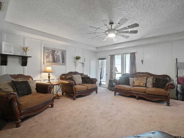 a living room with furniture and a chandelier