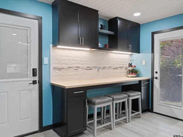 a kitchen with a sink cabinets and wooden floor