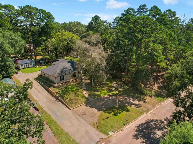 a view of a yard with wooden fence
