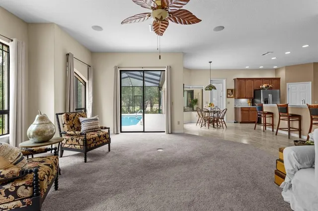 a dining room with furniture wooden floor and a chandelier