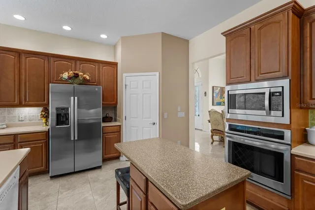 a spacious bedroom with a bed and a chandelier