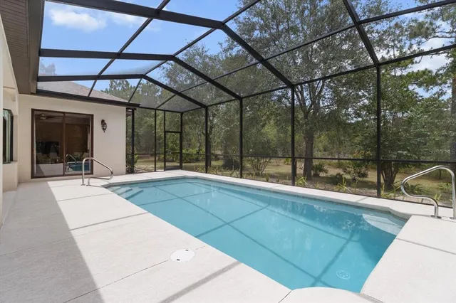 a dining room with furniture and a floor to ceiling window