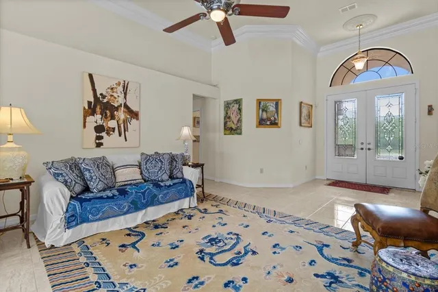 a living room with furniture and a chandelier