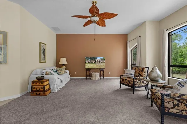a living room with furniture and a large window
