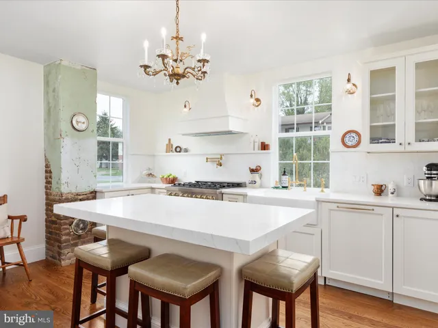 a kitchen with stainless steel appliances a stove refrigerator sink and cabinets