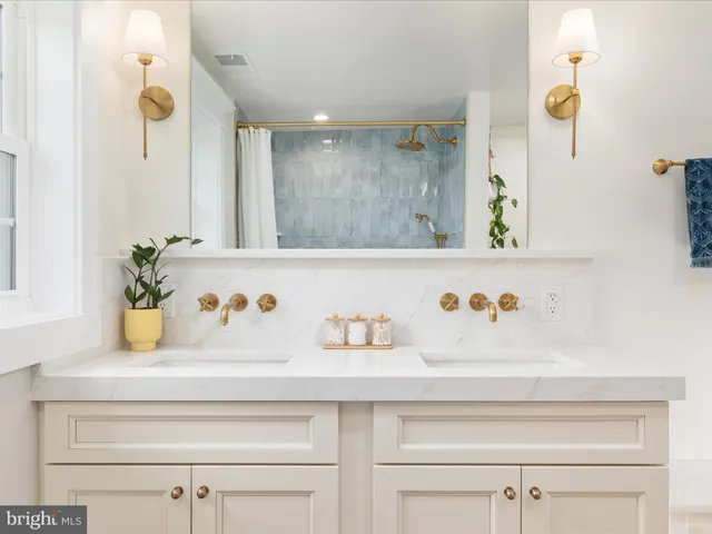 a view of a house with a yard and large tree