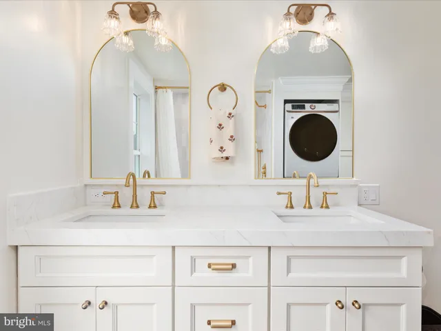 an aerial view of a city with lots of residential buildings ocean and mountain view in back