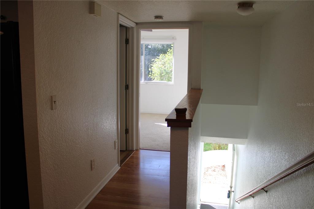 9720 Indian Key Trail, Unit 117 Seminole, FL 33776 - Photo 22 of 92 a view of hallway with wooden floor
