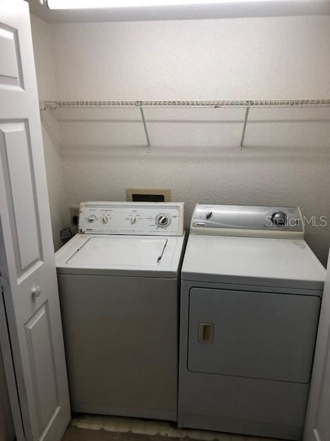9720 Indian Key Trail, Unit 117 Seminole, FL 33776 - Photo 38 of 92 a utility room with dryer and washer