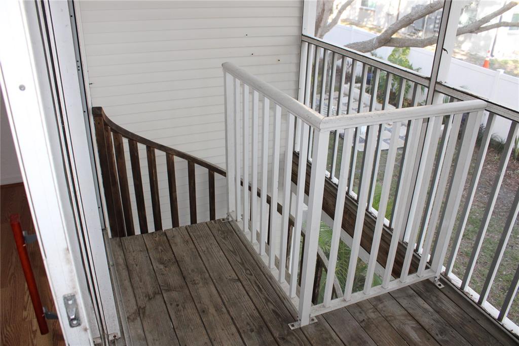 9720 Indian Key Trail, Unit 117 Seminole, FL 33776 - Photo 53 of 92 a view of staircase with wooden floor and a window