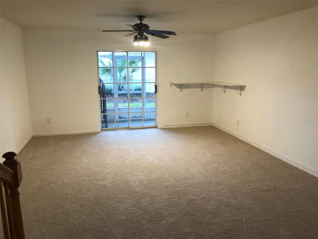 9720 Indian Key Trail, Unit 117 Seminole, FL 33776 - Photo 62 of 92 an empty room with windows and ceiling fan