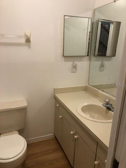 9720 Indian Key Trail, Unit 117 Seminole, FL 33776 - Photo 67 of 92 a bathroom with a toilet sink and mirror