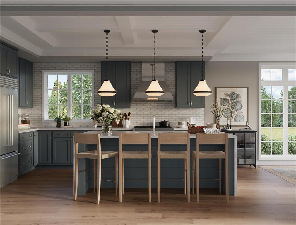 102 Ramsgate Road, Unit WARRINGTON Cranberry Township, PA 16066 - Photo 25 of 42 a kitchen with stainless steel appliances granite countertop a stove top oven a sink a dining table and chairs with wooden floor