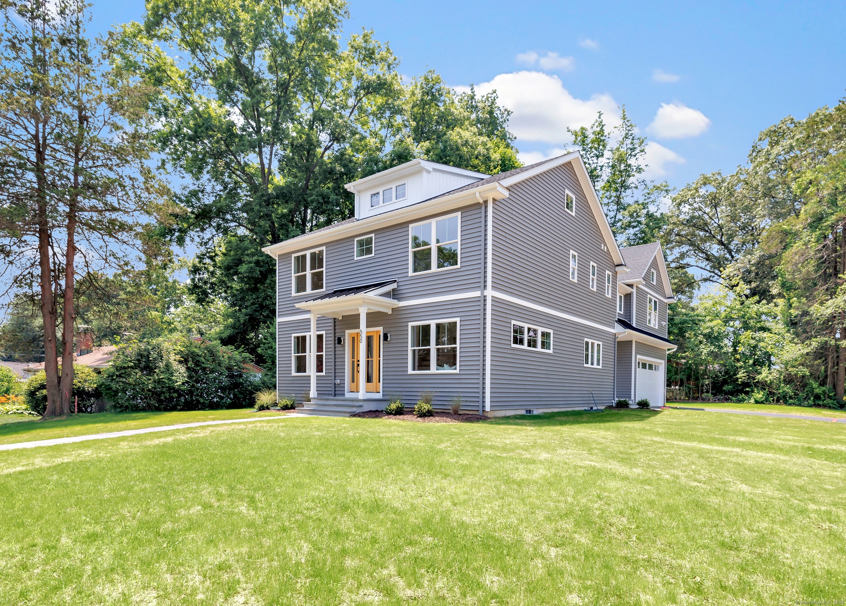 550 Davis Road Fairfield, CT 06825 - Photo 1 of 1 a front view of house with yard and trees in the background