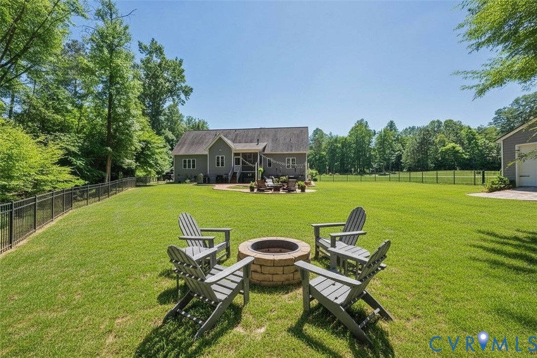 6446 Chestnut Church Road Mechanicsville, VA 23116 - Photo 38 of 49 Expansive green lawn featuring a stone-clad fire p