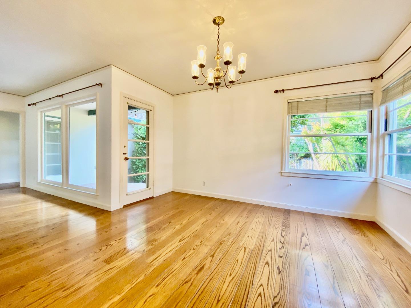 569 Alhambra Road San Mateo, CA 94402 - Photo 14 of 30 a view of an empty room with wooden floor and a window