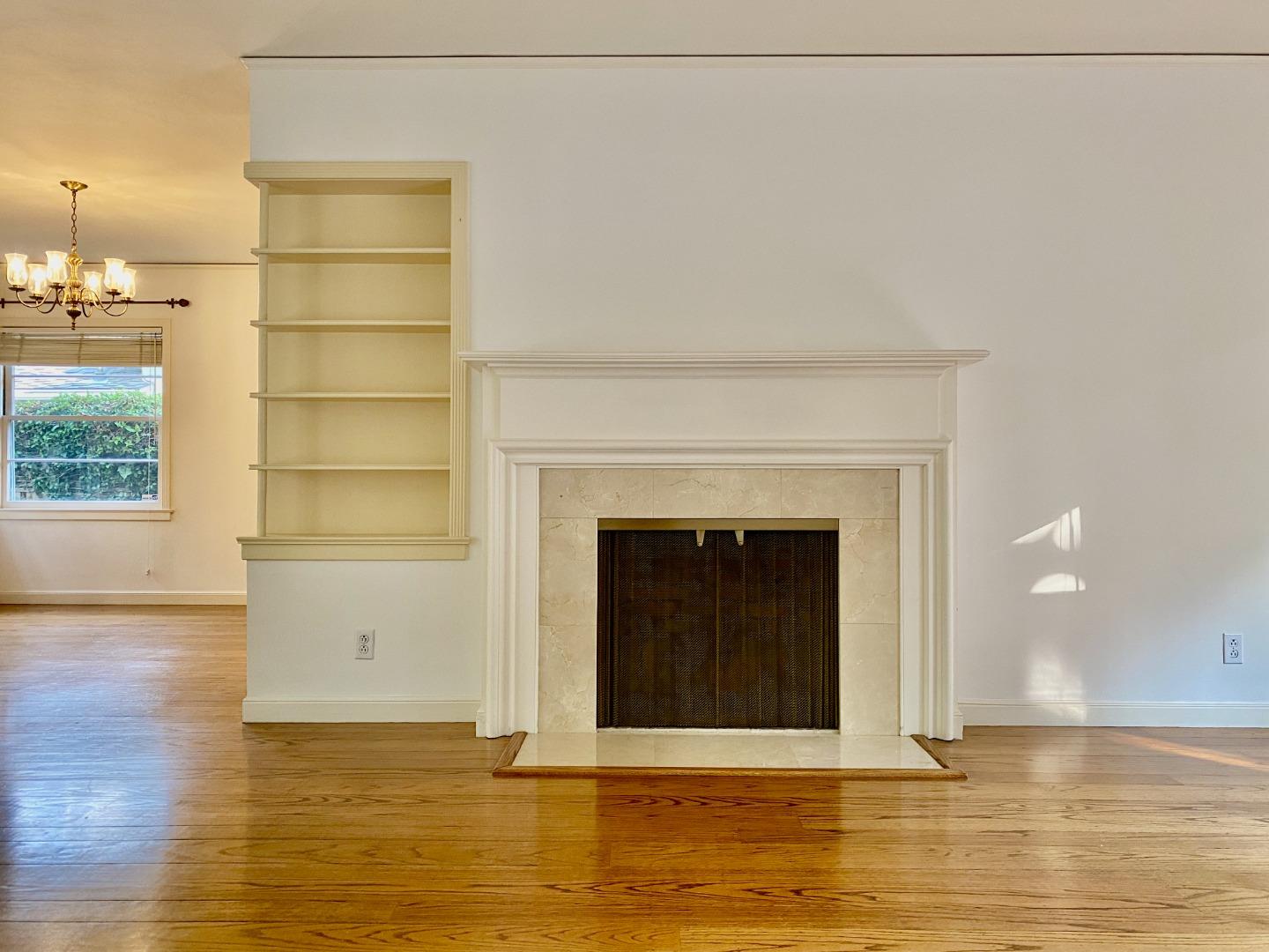 569 Alhambra Road San Mateo, CA 94402 - Photo 10 of 30 a view of a livingroom with a fireplace and wooden floor