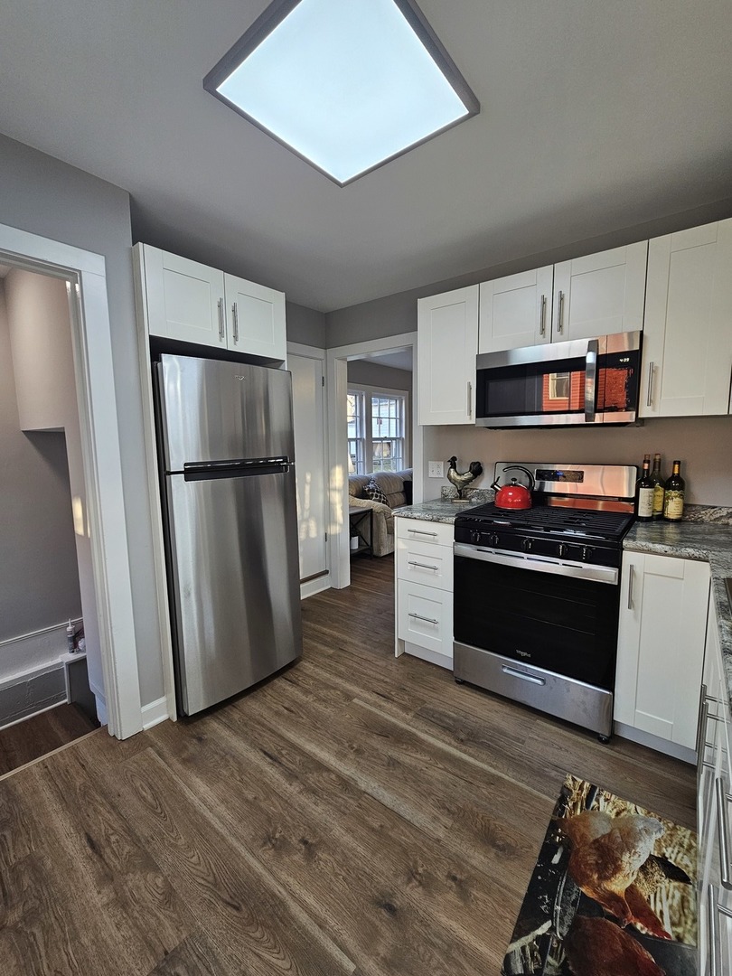 220 South Walnut Street Sycamore, IL 60178 - Photo 5 of 13 a kitchen with a refrigerator and a stove top oven