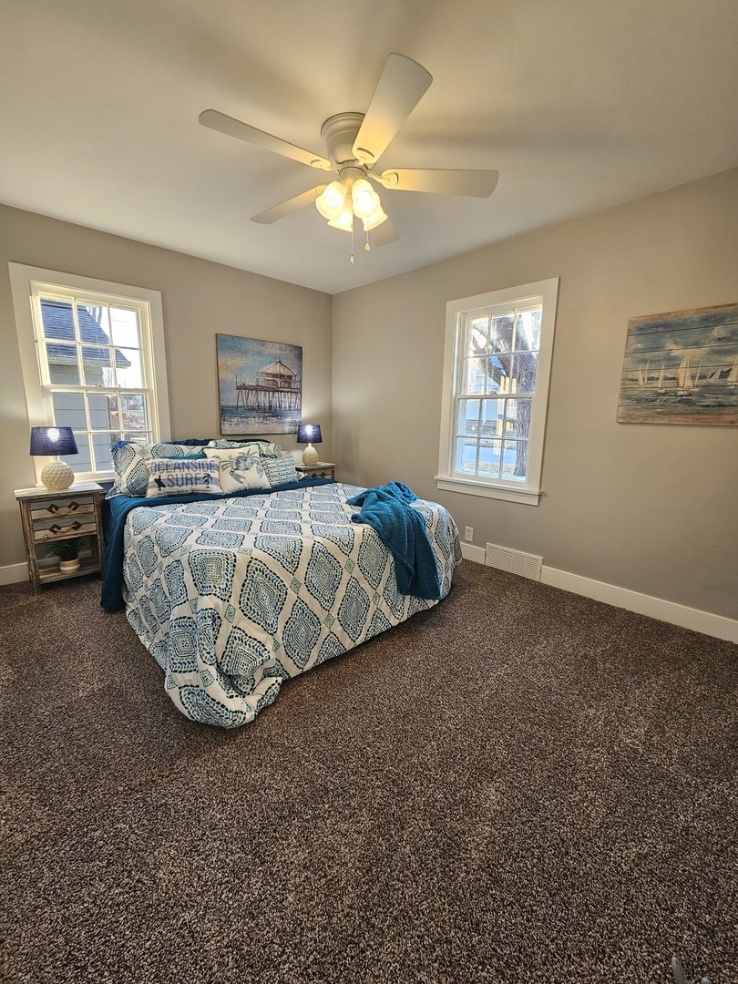 220 South Walnut Street Sycamore, IL 60178 - Photo 7 of 13 a spacious bedroom with a bed and a chandelier