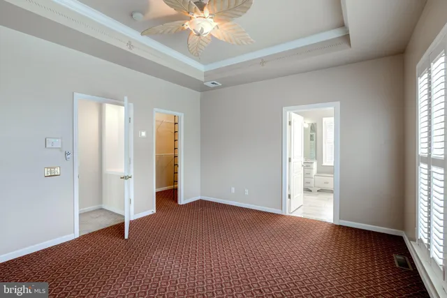 a spacious bathroom with a double vanity sink a large mirror and a bathtub next to a window