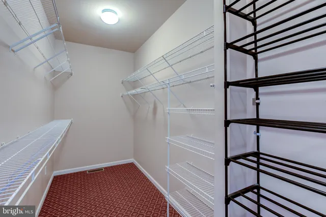a bathroom with double vanity and a large mirror
