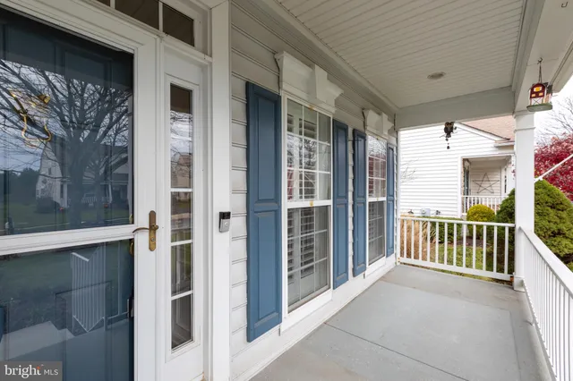 a view of a porch with a table and chairs