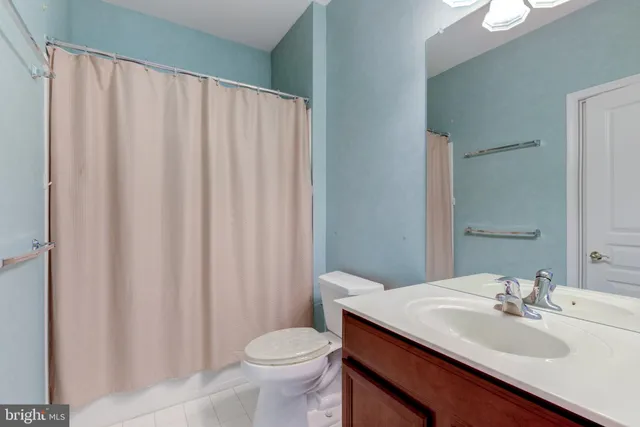 an empty room with ceiling fan and window
