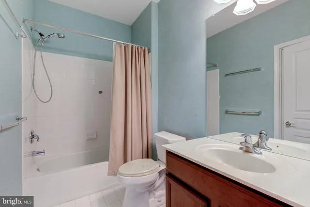 an empty room with a window and a ceiling fan