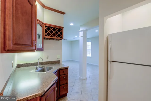 an empty room with wooden floor and empty shelves