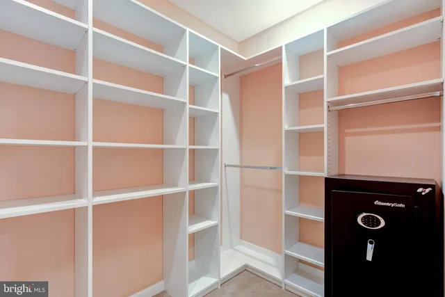 a view of an empty room with tv and wooden floor