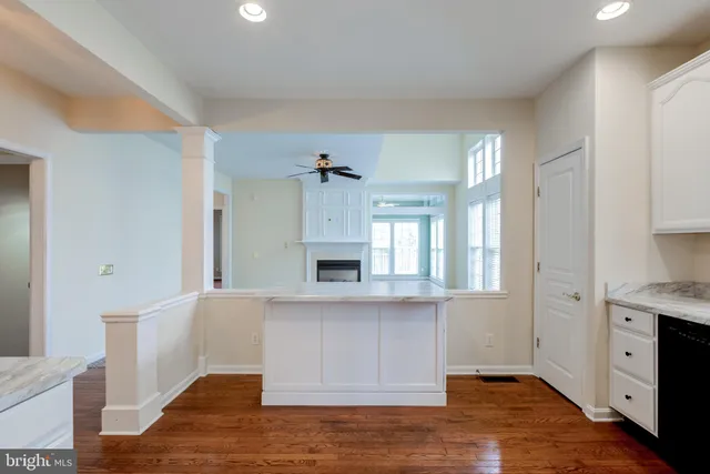 a view of a kitchen with a sink a cabinet and windows