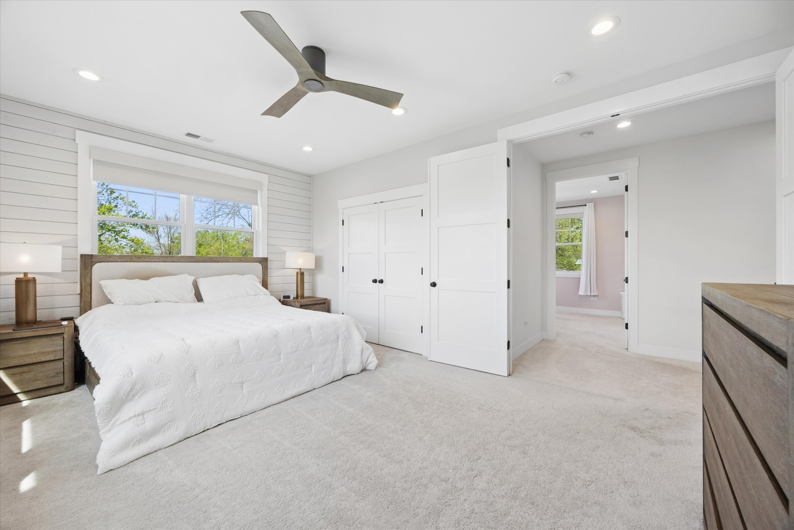 16W185 89th Street Burr Ridge, IL 60527 - Photo 22 of 44 a spacious bedroom with a large bed and a chandelier