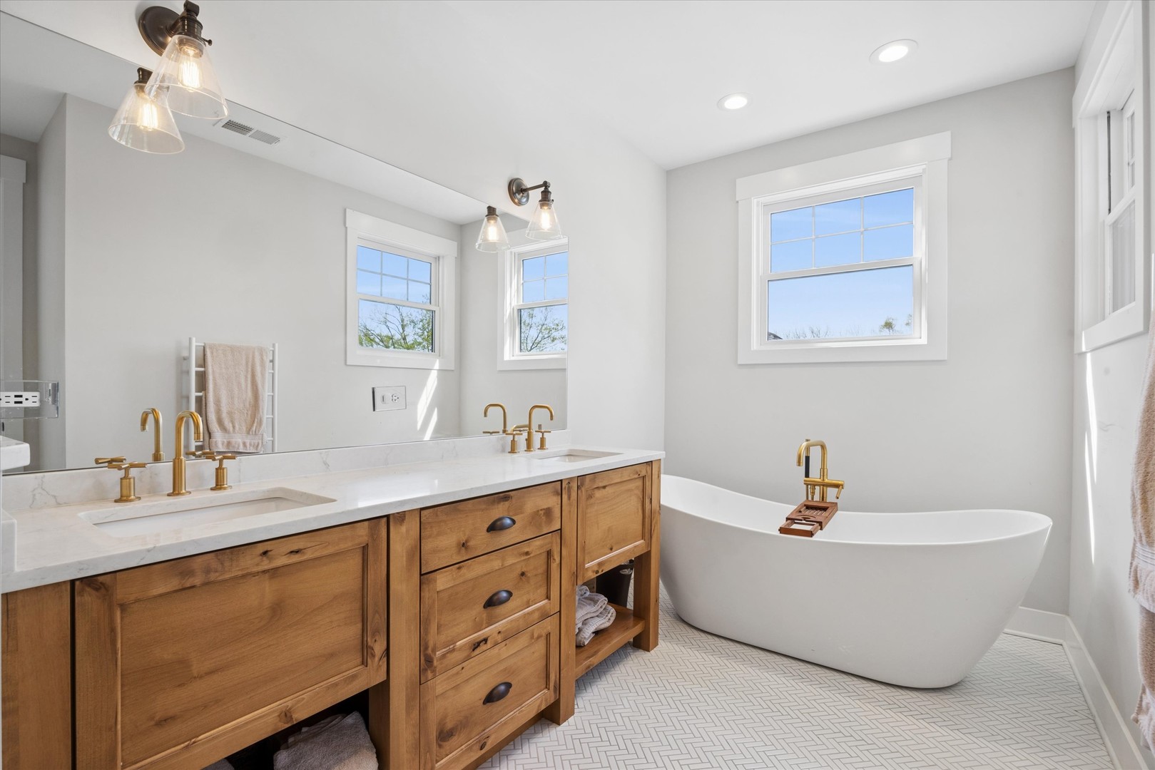 16W185 89th Street Burr Ridge, IL 60527 - Photo 23 of 44 a bathroom with a double vanity sink a bathtub and shower