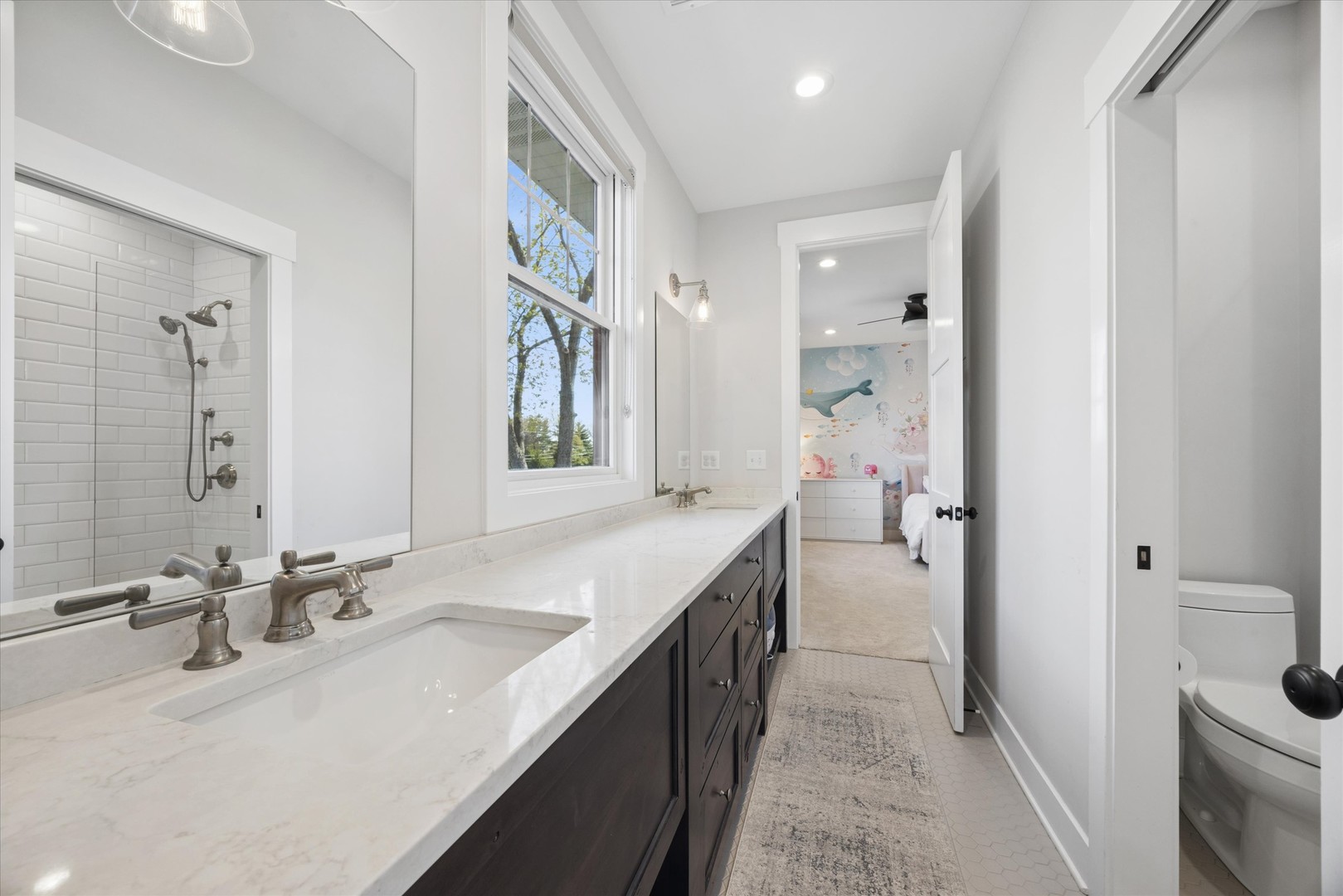 16W185 89th Street Burr Ridge, IL 60527 - Photo 27 of 44 a bathroom with a double vanity sink a toilet and a mirror