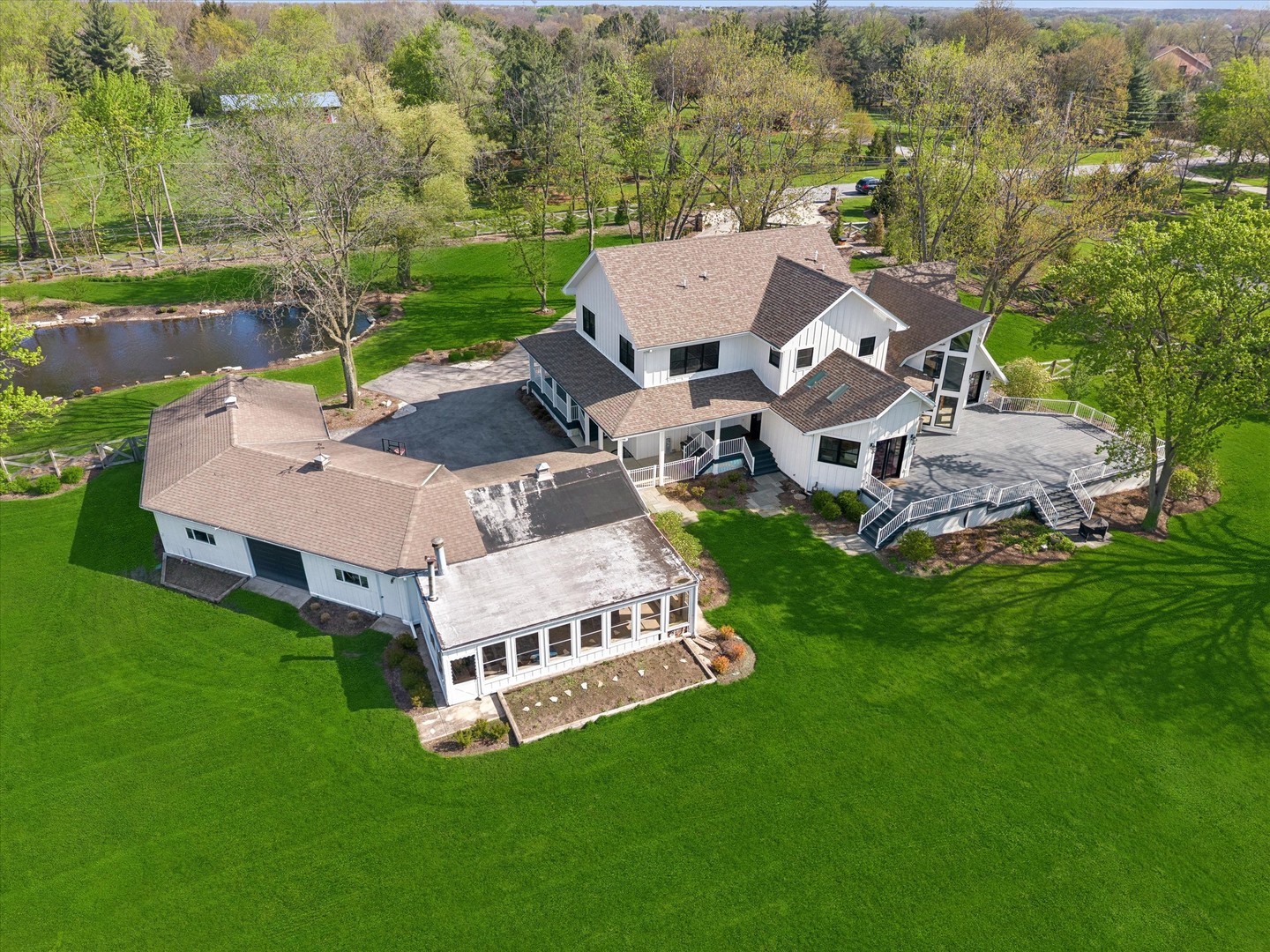 16W185 89th Street Burr Ridge, IL 60527 - Photo 3 of 44 an aerial view of a house with backyard garden and lake view