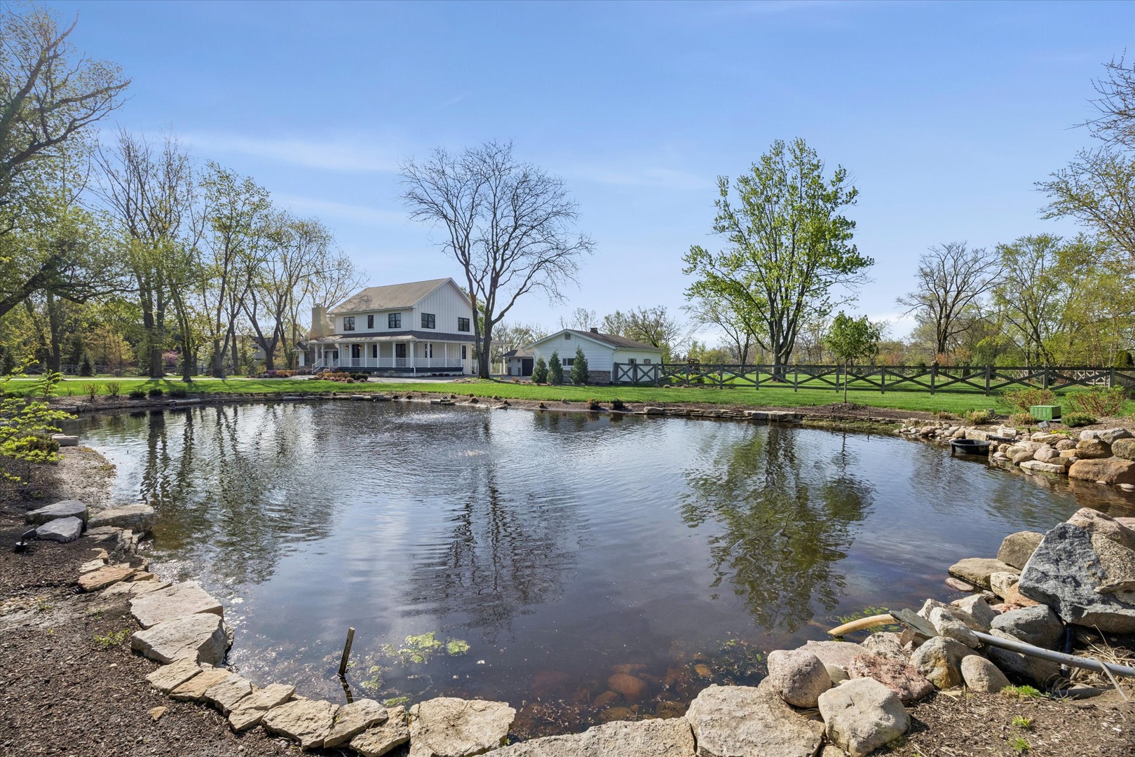 16W185 89th Street Burr Ridge, IL 60527 - Photo 31 of 44 a view of a lake with a house in the background