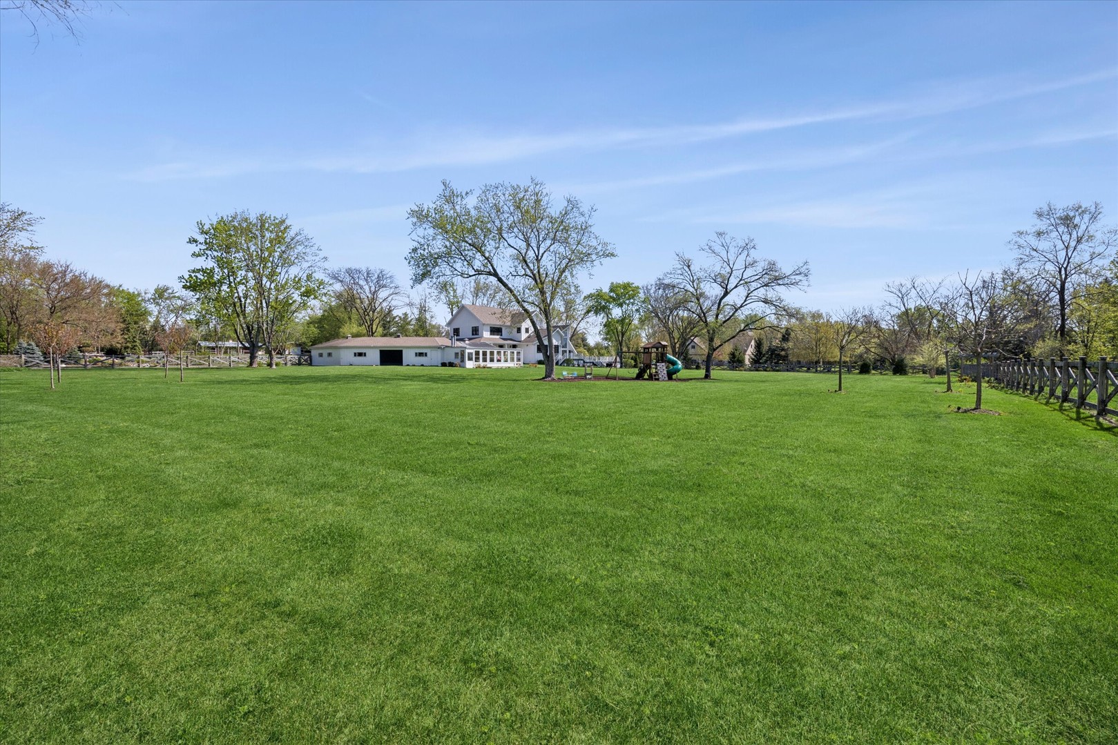 16W185 89th Street Burr Ridge, IL 60527 - Photo 36 of 44 a grassy field with trees in the background