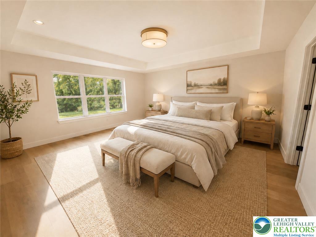 3104 Moyer Road Hellertown, PA 18055 - Photo 3 of 24 Natural light streams across rich wood flooring beneath an elegant tray ceiling.