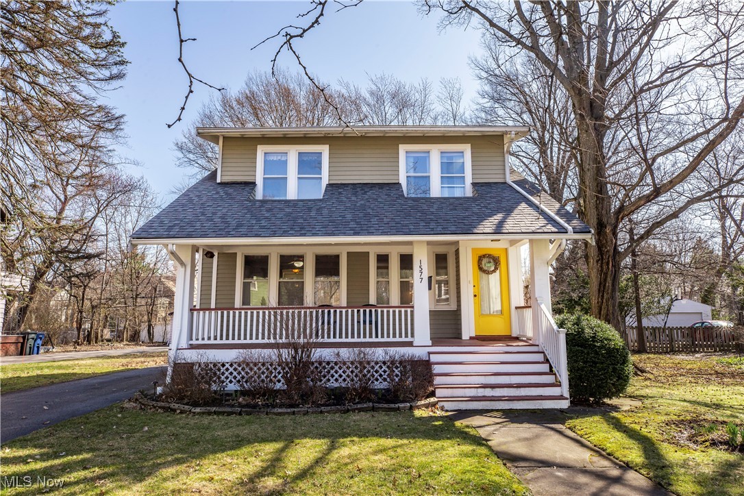 View of front of house, front lawn, and porch.